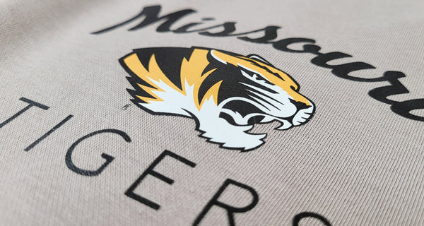 A full-color print of a tiger logo on a grey sweatshirt, close up