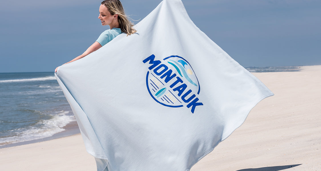 A printed Pro-Weave sweatshirt blanket on the beach